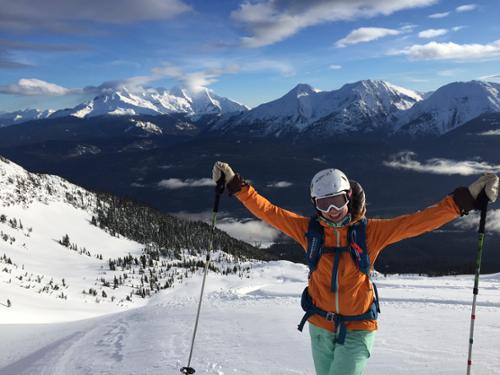 Krista Crabtree celebrates while heliskiing with White Wilderness Heliskiing in Canada.