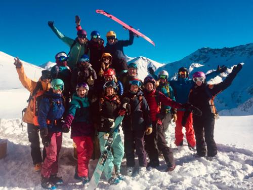 A group of women celebrate the ski day and blue sky at Silverton Mountain.