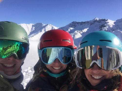 Three women in helmets, goggles and big smiles celebrate the day at Silverton Mountain.