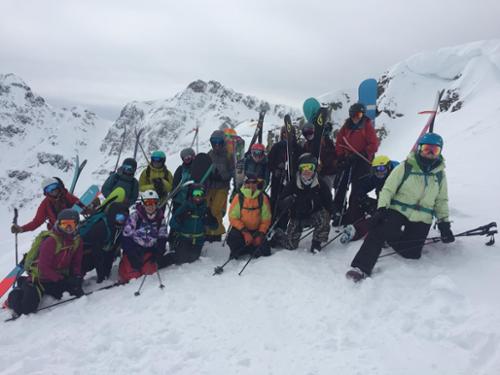 A group of women pose for a picture at the top of a cornice at Silverton Mountain.